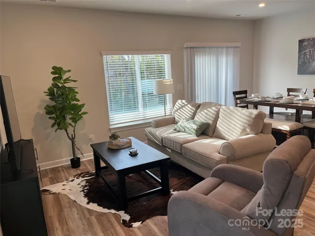 a living room with furniture and a potted plant