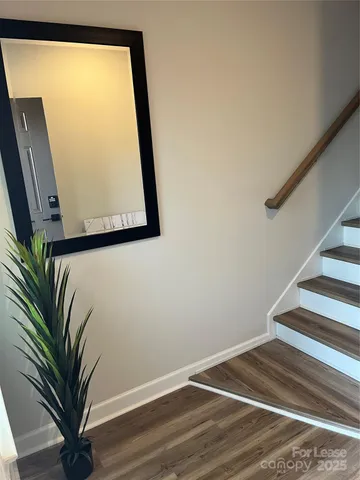 a view of staircase with wooden floor and a window