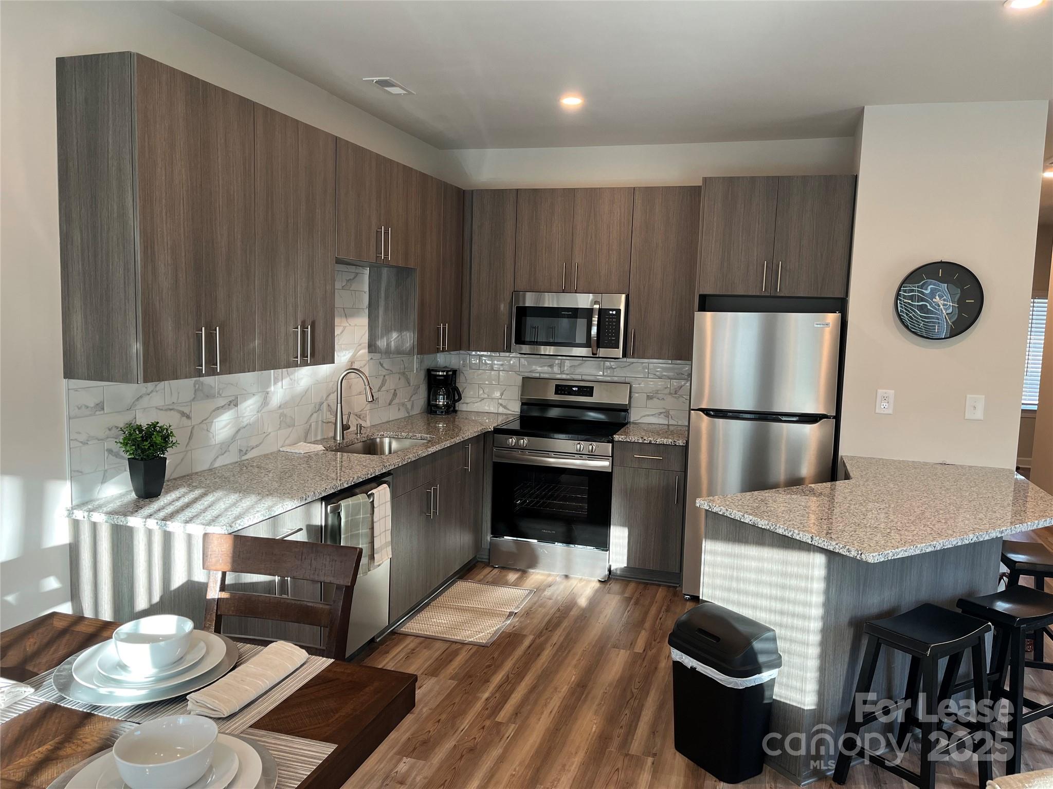 226 South Elm Street Pageland, SC 29728 - Photo 2 of 23 a kitchen with granite countertop a stove a sink and a refrigerator