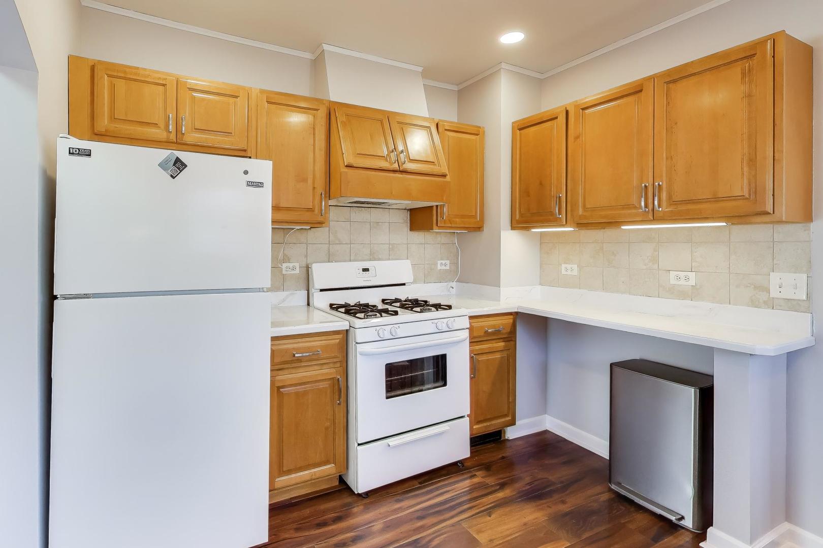 440 West Main Street Barrington, IL 60010 - Photo 12 of 32 a kitchen with a refrigerator sink and cabinets