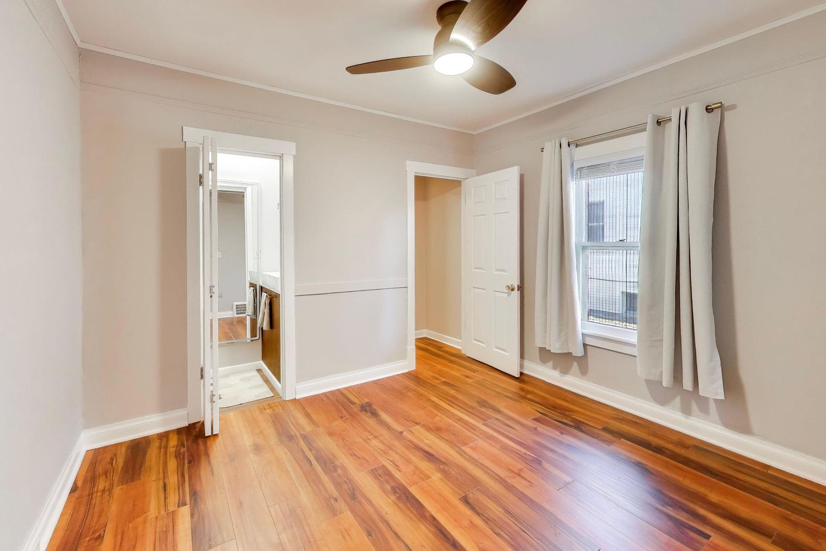 440 West Main Street Barrington, IL 60010 - Photo 18 of 32 an empty room with wooden floor cabinet and windows