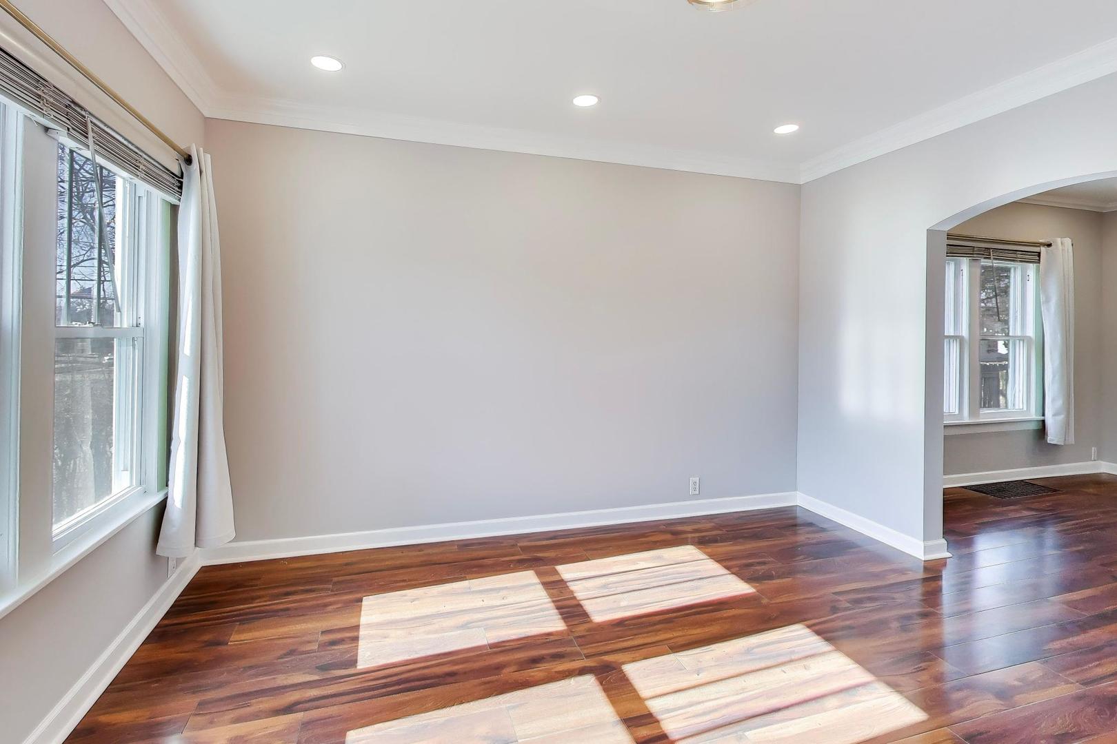 440 West Main Street Barrington, IL 60010 - Photo 7 of 32 a view of an empty room with wooden floor and a window