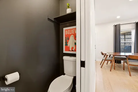 a bathroom with a toilet a sink and a window