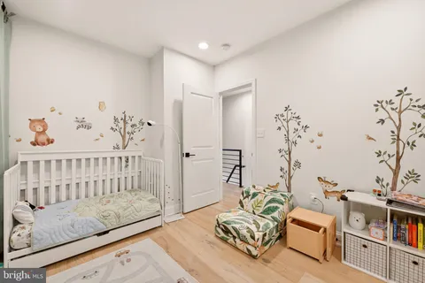 a bedroom with furniture and wooden floor
