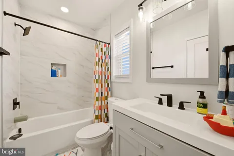 a bathroom with a sink a toilet and a bathtub