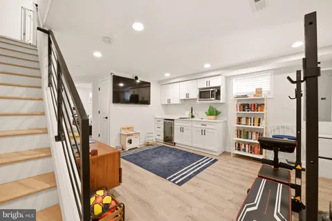 a living room with furniture a flat screen tv and a table