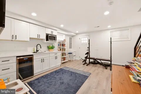 a kitchen with a sink appliances and cabinets