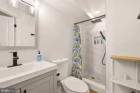 a bathroom with a sink toilet and shower