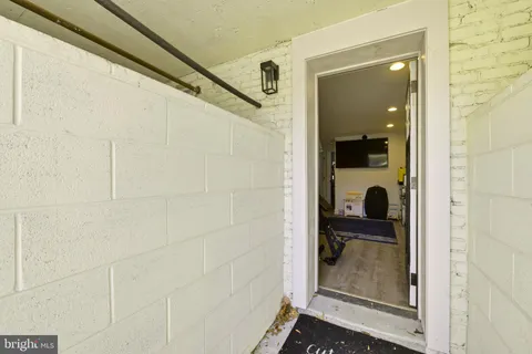 a bathroom with a glass door shower and a sink