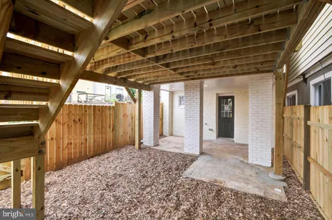 a view of backyard with wooden fence