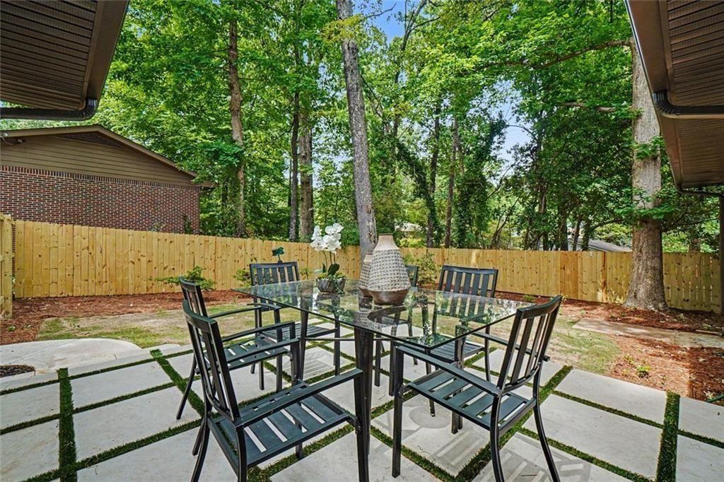 2700 Hawaii Court Decatur, GA 30033 - Photo 28 of 31 a view of a patio with table and chairs and wooden fence