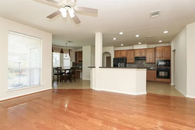 a view of kitchen with kitchen island and stainless steel appliances