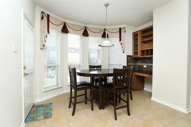 a view of a dining room that has a table and chairs