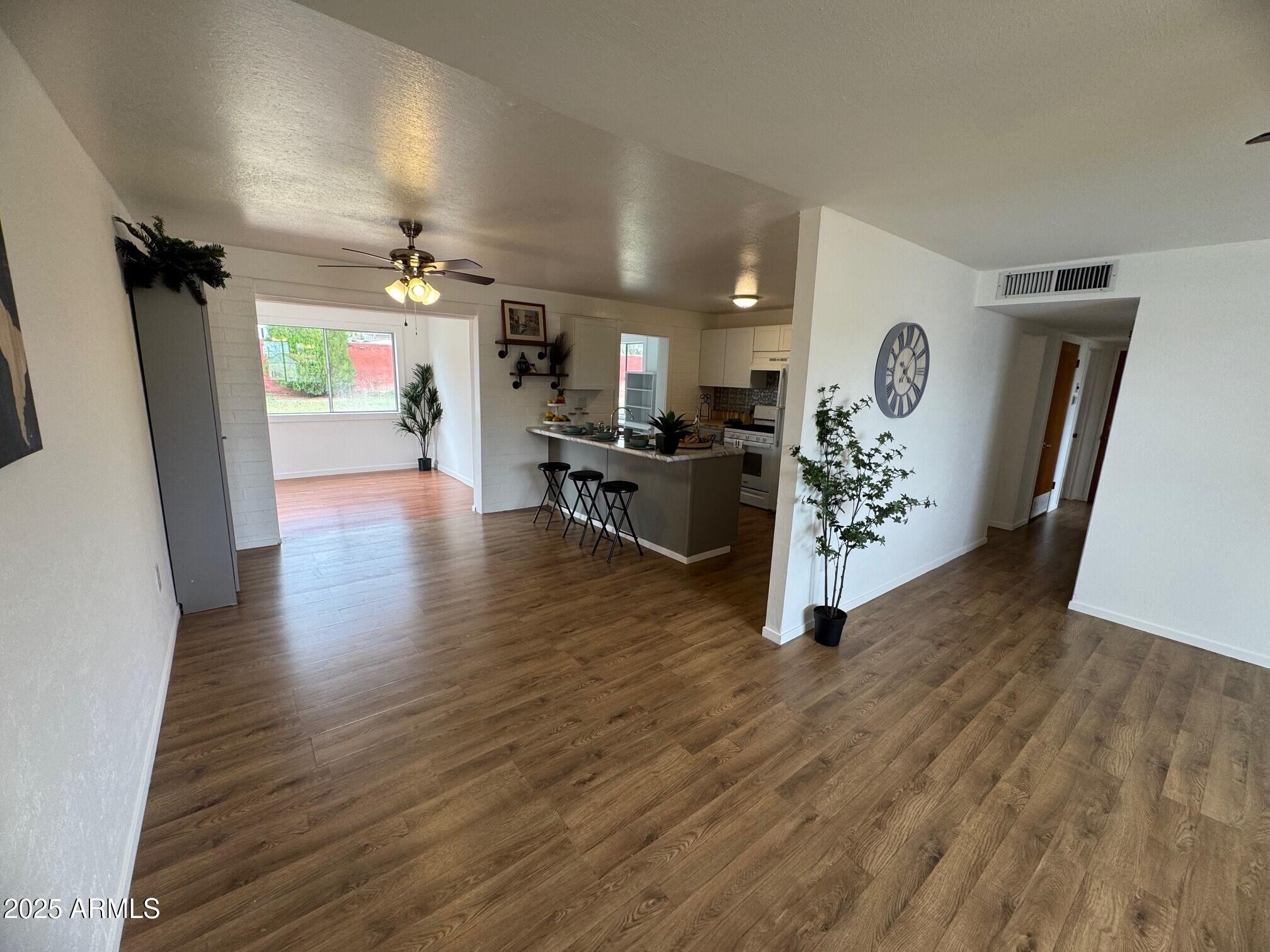504 Alegre Place Bisbee, AZ 85603 - Photo 8 of 28 a living room with furniture and a wooden floor