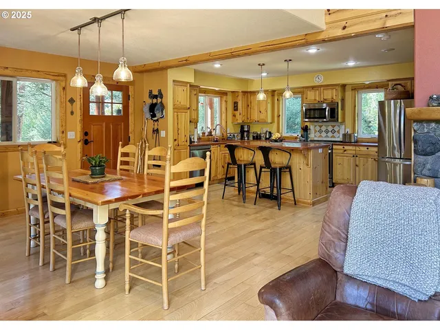 a room with lots of white furniture and chandelier