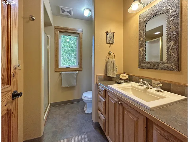 a bathroom with a sink a toilet and a mirror