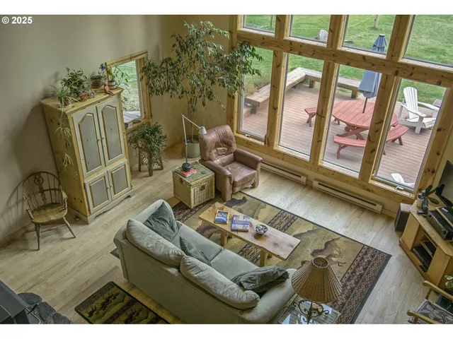 a living room with furniture and a floor to ceiling window