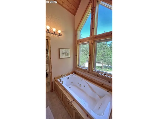 a living room with a bed and a window