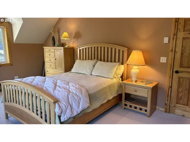 a bedroom with a bed and window