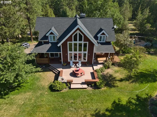 a front view of a house with a yard table and chairs