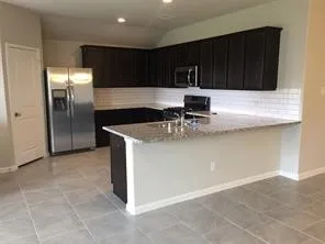 a kitchen with stainless steel appliances granite countertop a sink and a stove top oven