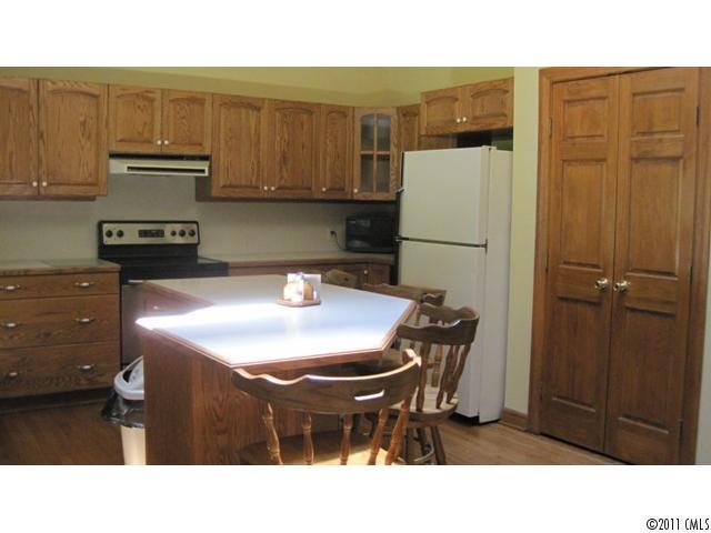 633 Marvin Road Indian Land, SC 29707 - Photo 6 of 16 a kitchen with a sink a refrigerator and cabinets
