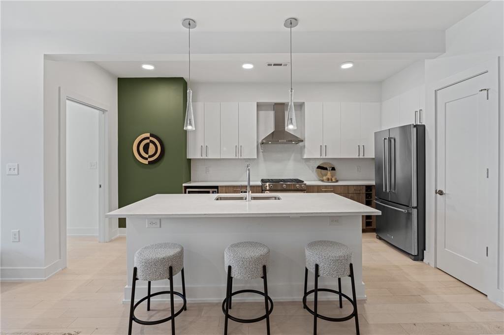 775 Juniper Street Northeast, Unit 227 Atlanta, GA 30308 - Photo 7 of 42 a kitchen with a refrigerator and a sink