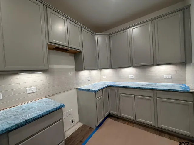 a kitchen with granite countertop cabinets a sink and dishwasher