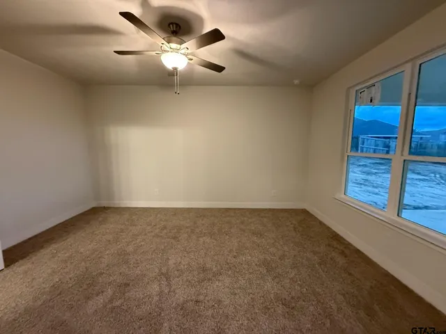 an empty room with a empty space and a ceiling fan