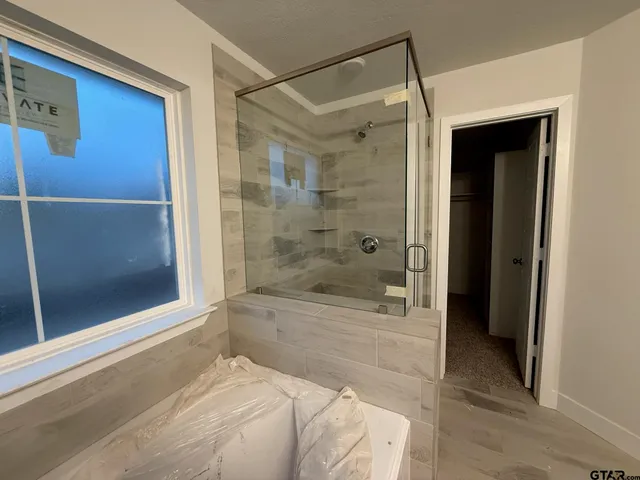 a bathroom with a shower and a bathtub