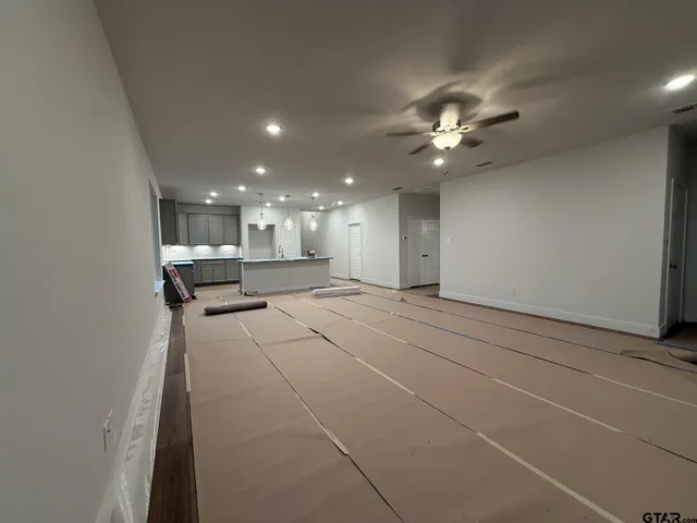 a view of an empty room with a kitchen