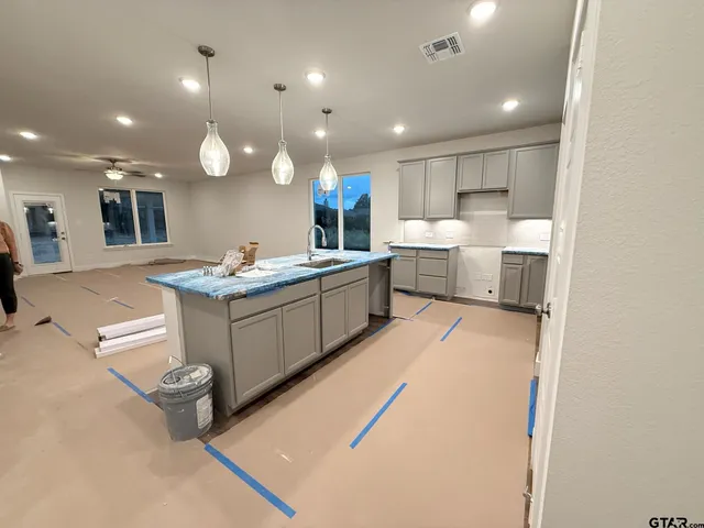 a kitchen with a sink appliances and cabinets