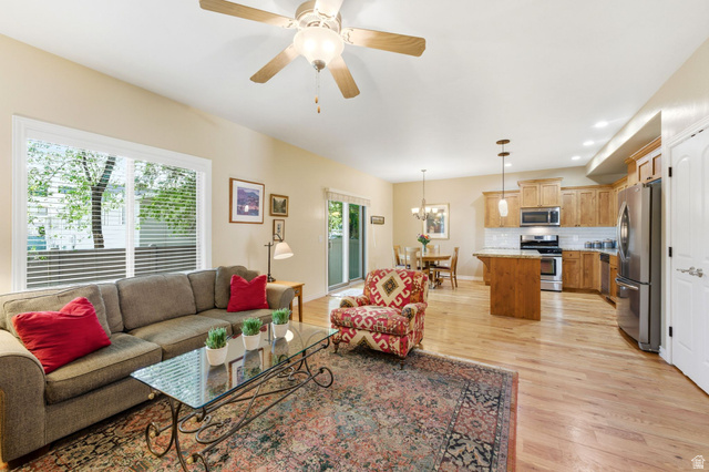 7235 Viansa Court Midvale, UT 84047 - Photo 5 of 43 Living area featuring light wood-style floors, hanging lights, and ceiling fan