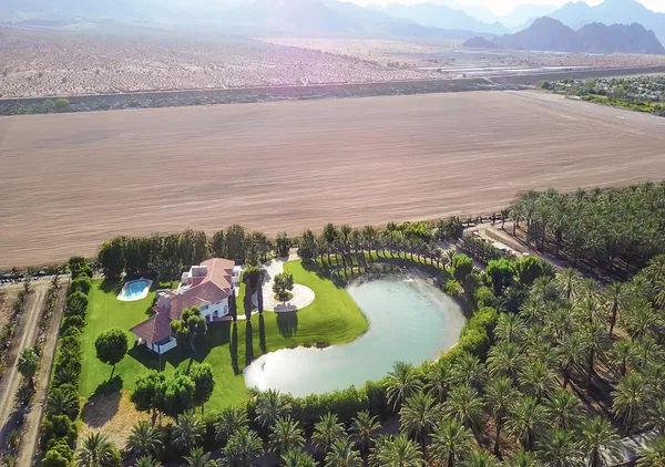 an aerial view of houses with outdoor space and swimming pool