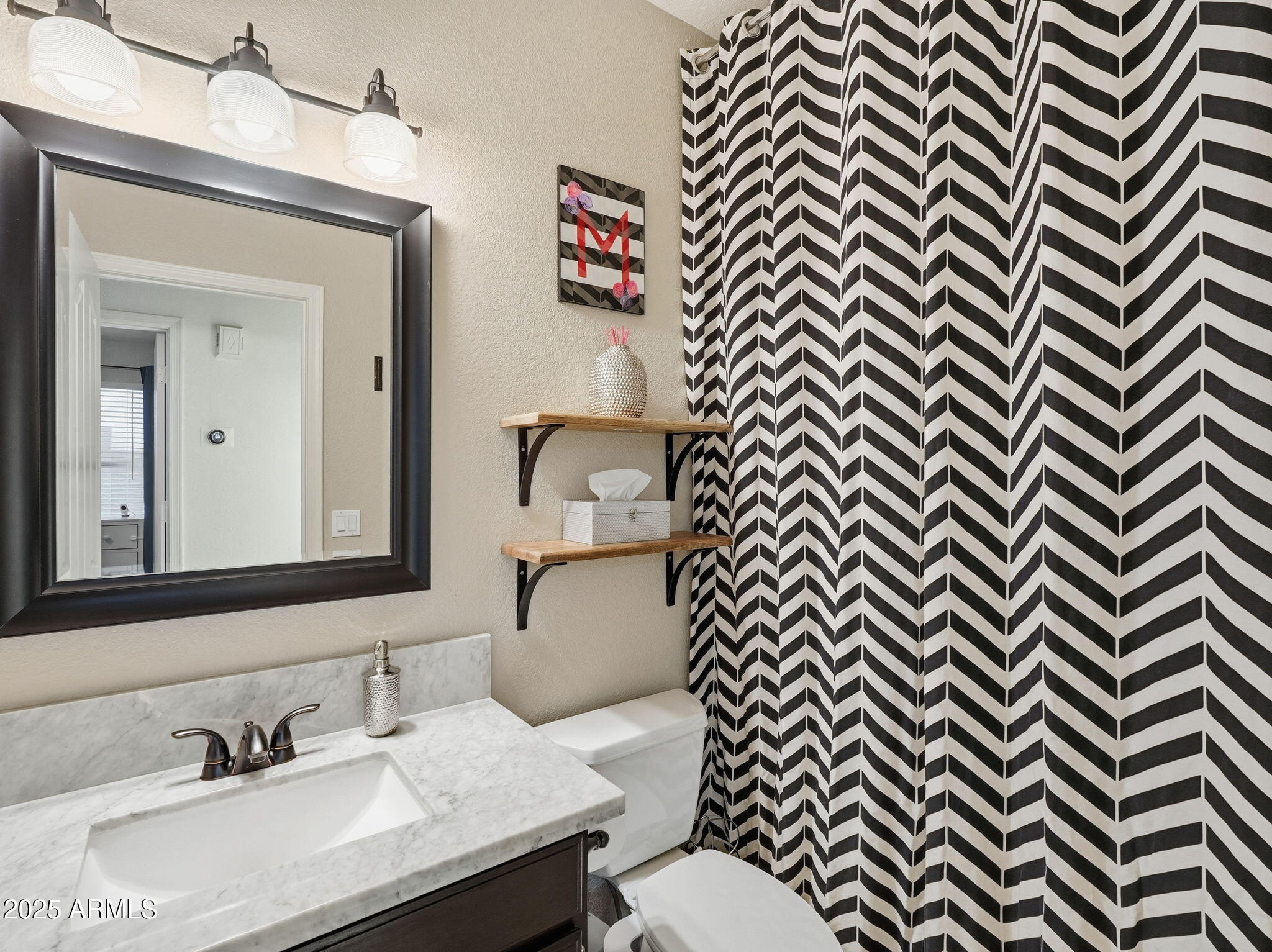 1516 East Cheyenne Street Gilbert, AZ 85296 - Photo 34 of 73 a bathroom with a sink a mirror and a toilet