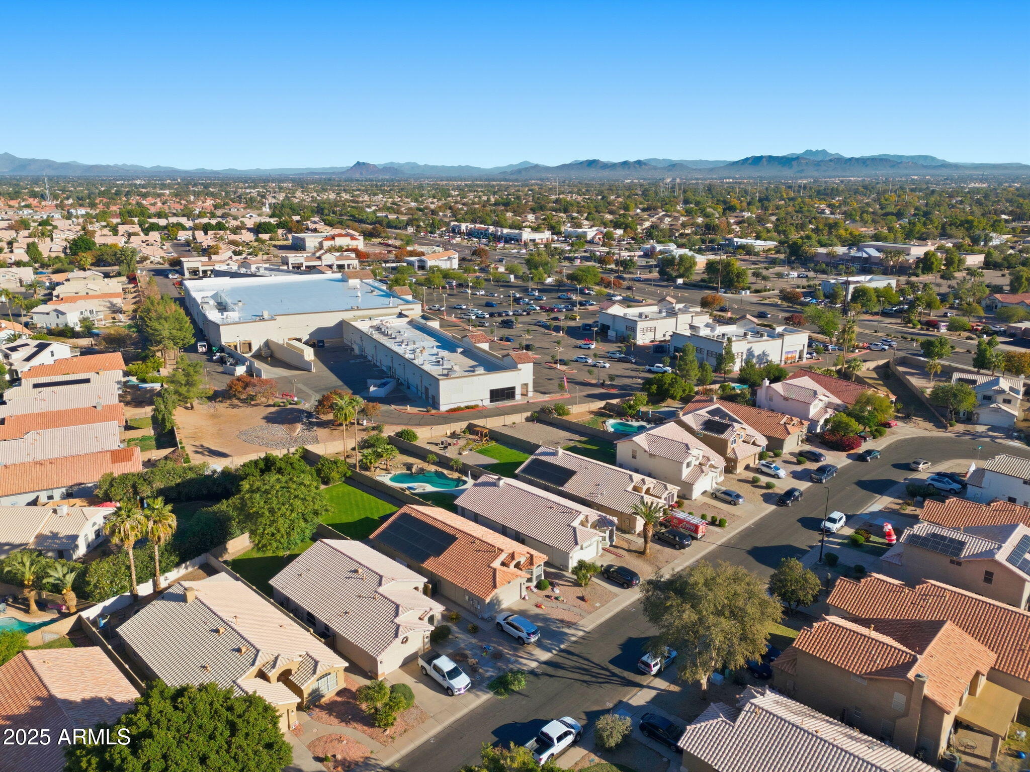 1516 East Cheyenne Street Gilbert, AZ 85296 - Photo 65 of 73 an aerial view of a city with lots of residential buildings and ocean view in back