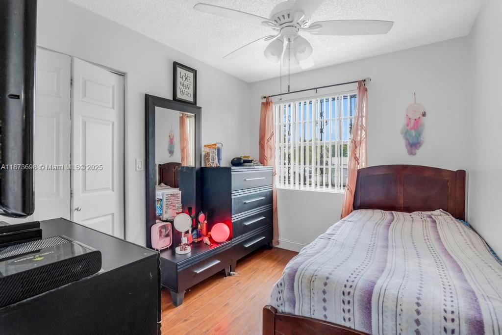 26023 Southwest 133rd Place Homestead, FL 33032 - Photo 19 of 39 a bedroom with a bed and a flat screen tv