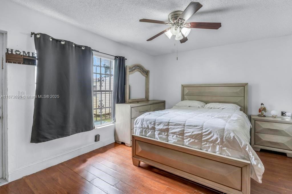 26023 Southwest 133rd Place Homestead, FL 33032 - Photo 23 of 39 a bedroom with a bed dresser and a window