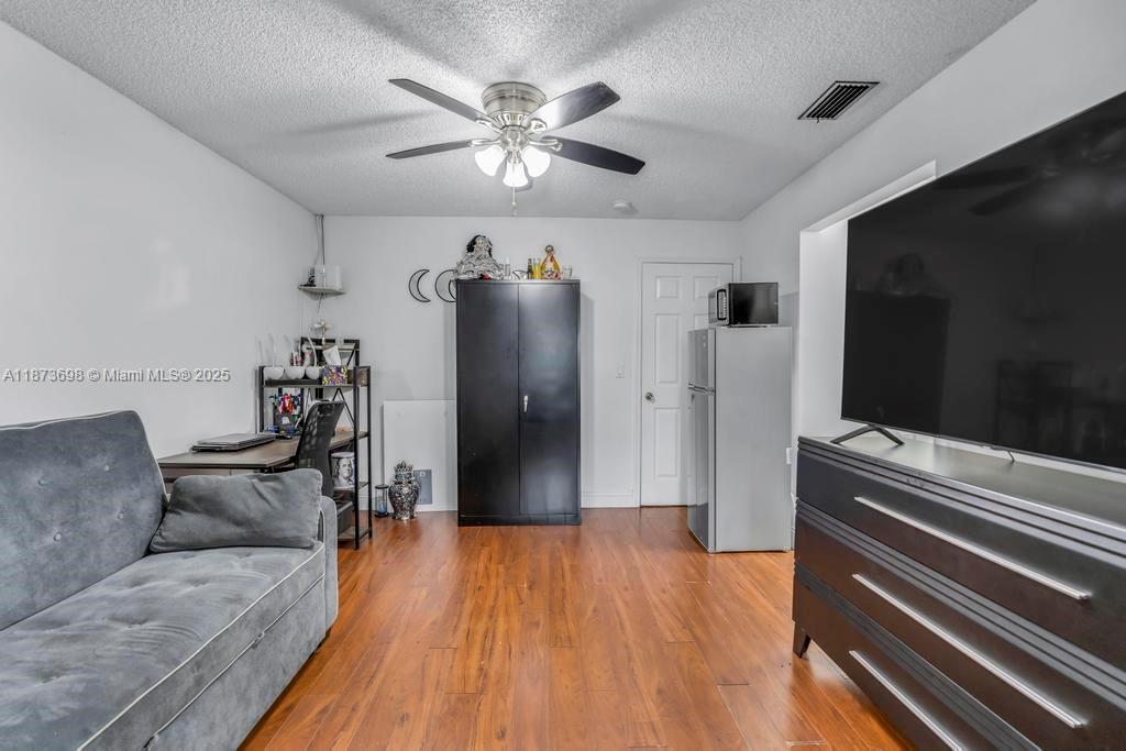 26023 Southwest 133rd Place Homestead, FL 33032 - Photo 24 of 39 a living room with furniture and a flat screen tv