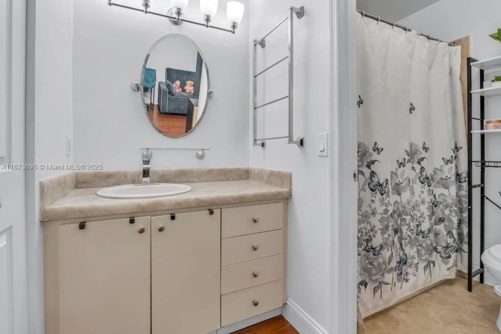 26023 Southwest 133rd Place Homestead, FL 33032 - Photo 25 of 39 a bathroom with a sink a mirror a vanity and a shower