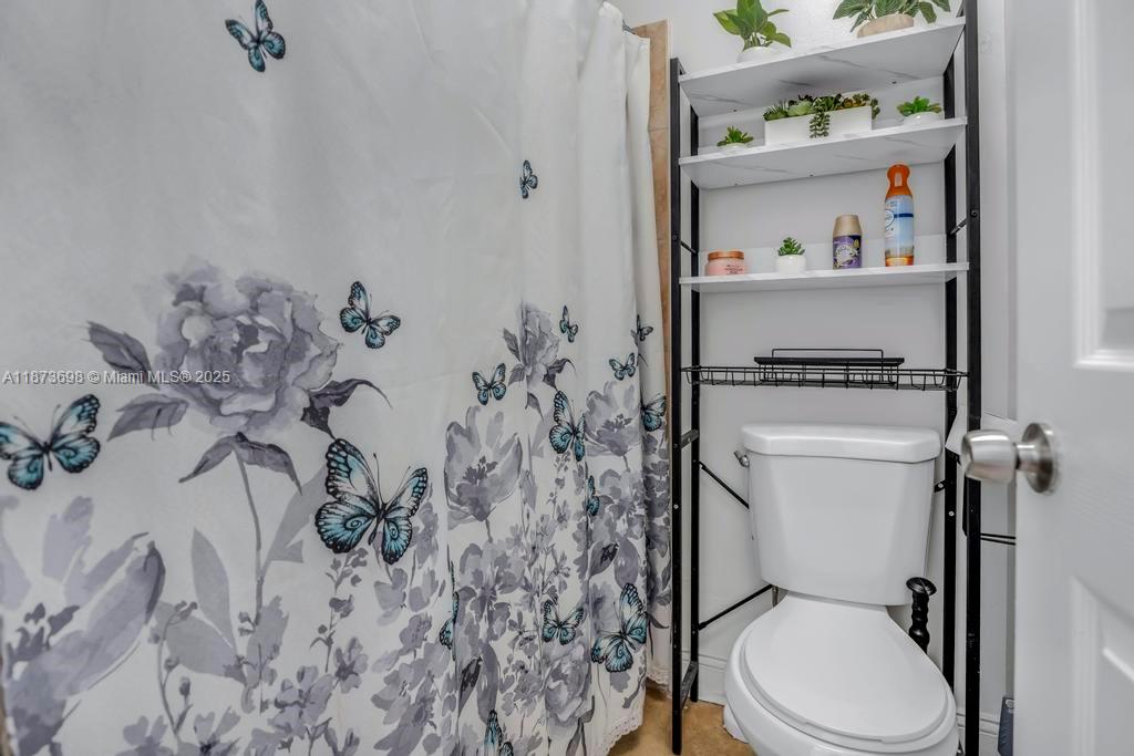 26023 Southwest 133rd Place Homestead, FL 33032 - Photo 26 of 39 a white toilet sitting next to a bathroom sink