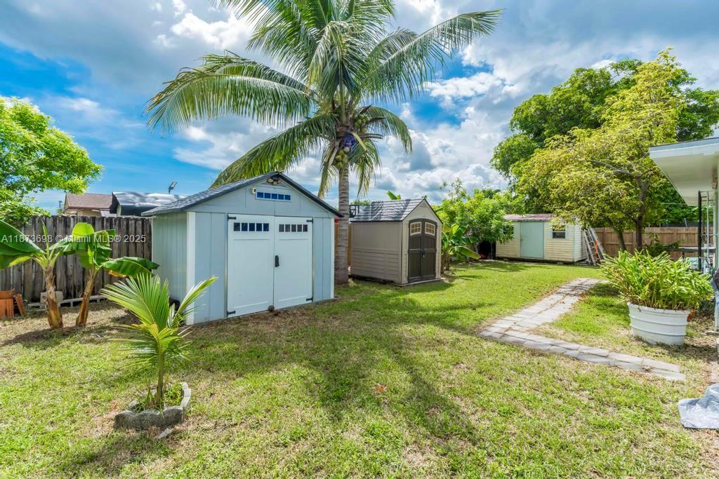 26023 Southwest 133rd Place Homestead, FL 33032 - Photo 27 of 39 a view of a house with a yard and potted plants