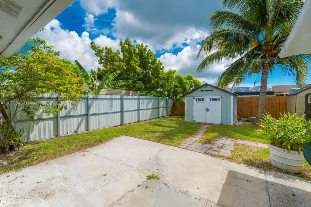 26023 Southwest 133rd Place Homestead, FL 33032 - Photo 29 of 39 a house with a yard and a wooden fence