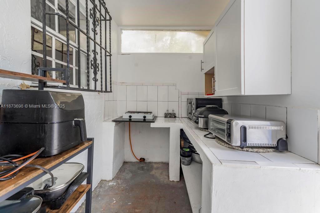 26023 Southwest 133rd Place Homestead, FL 33032 - Photo 33 of 39 a kitchen that has a sink and a stove