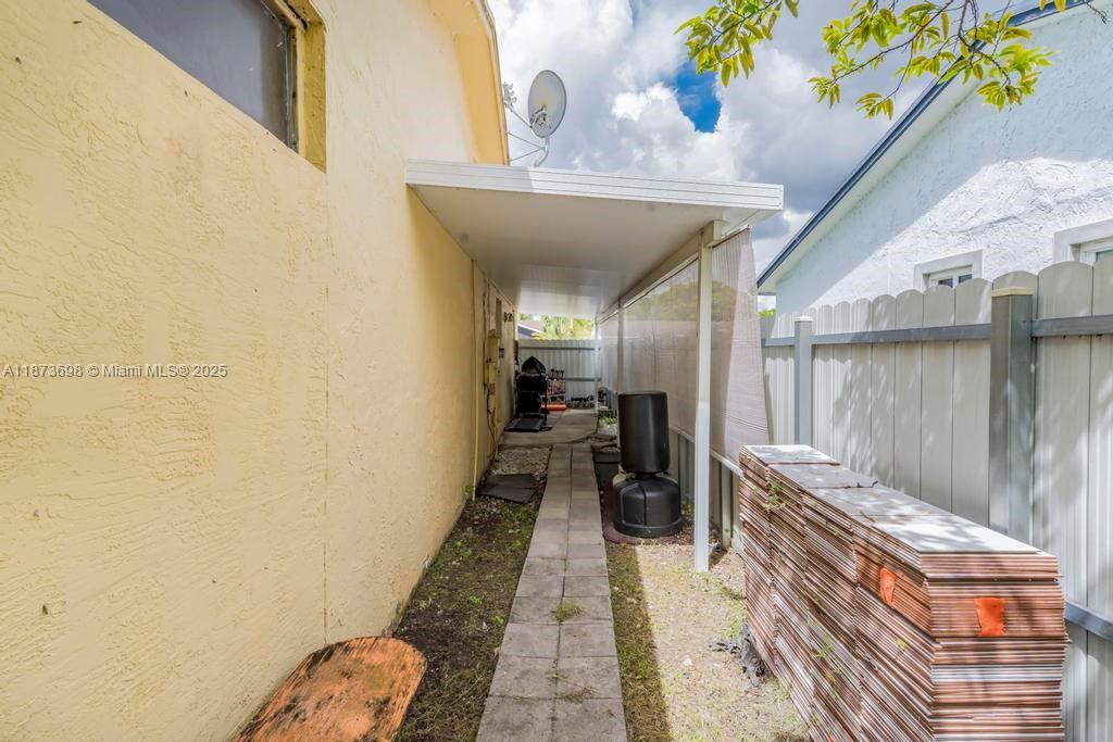 26023 Southwest 133rd Place Homestead, FL 33032 - Photo 34 of 39 a hallway with painting on the wall and a potted plant