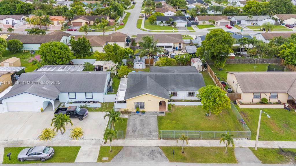 26023 Southwest 133rd Place Homestead, FL 33032 - Photo 35 of 39 an aerial view of residential houses with outdoor space and parking