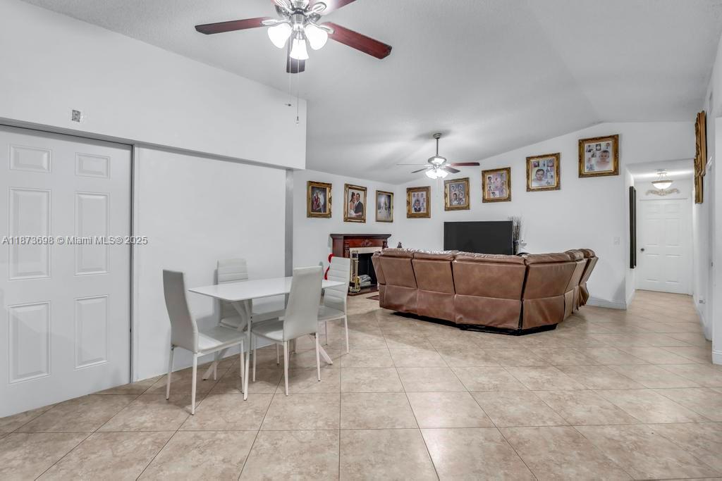 26023 Southwest 133rd Place Homestead, FL 33032 - Photo 10 of 39 a living room with furniture and a chandelier