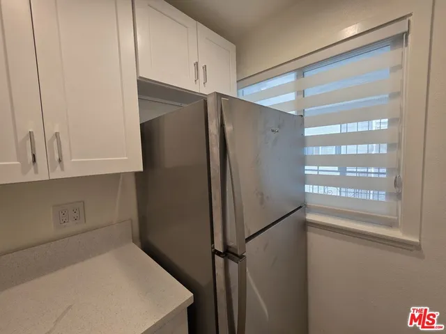a kitchen with metallic refrigerator freezer and a dishwasher