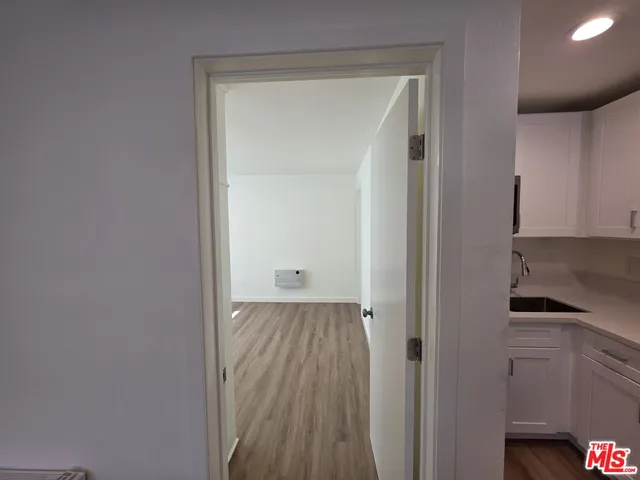 a view of a room with wooden floor and closet