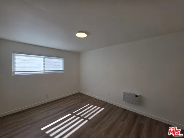 a view of a room with wooden floor and windows